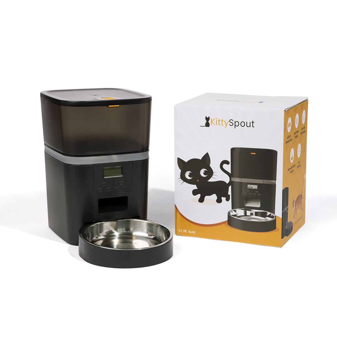Automatic pet feeder with digital controls and metal bowl beside the product packaging displaying a cat illustration.